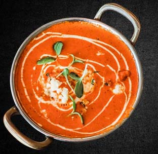 Tender indian butter chicken murgh makhani in creamy tomato gravy at best mexican restaurant in singapore